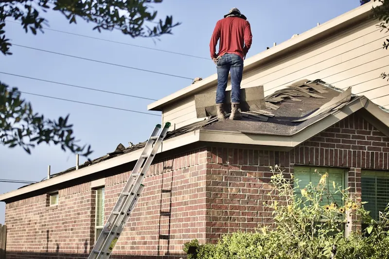 Professional roofer working on a residential roof in Mill Plain